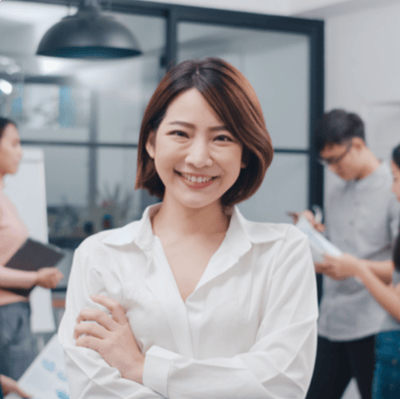 smiling asian female restaurant manager in dining area