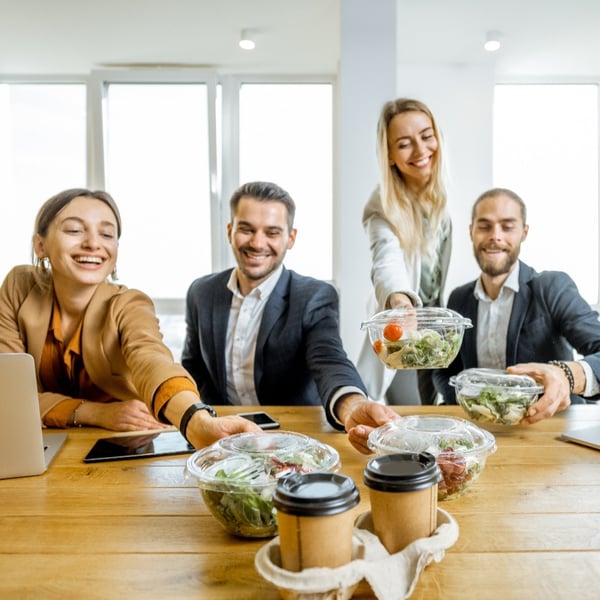 smiling friends at lunch table eating healthy foods-1