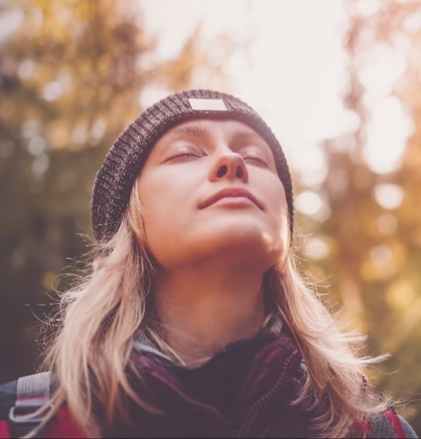 young blonde female outdoors winter apparel taking seep breath crop